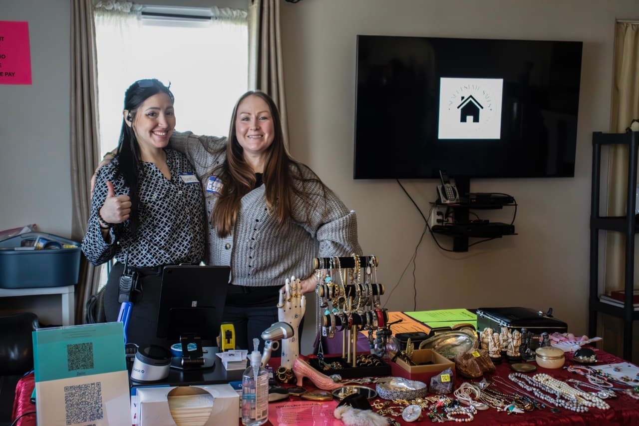 Two estate sale vendors pose for the camera